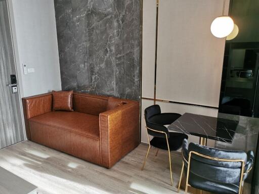 Modern living area with leather sofa and dining table