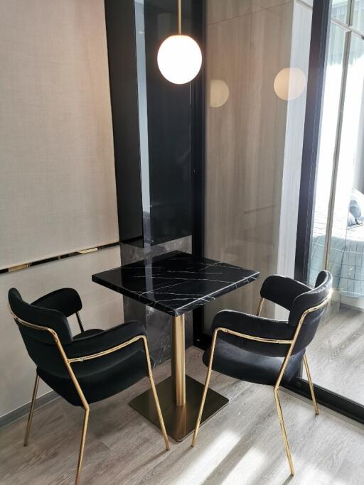 Cozy dining space with a black marble table and modern chairs