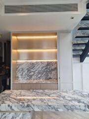 Modern kitchen with marble countertops and open shelving