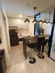 Modern kitchen with bar counter and stools