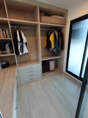 Spacious open closet with hanging space and shelves