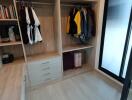 Spacious open closet with hanging space and shelves