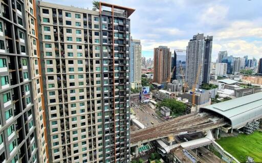 View of cityscape with tall buildings and urban railway