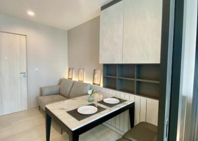 Modern living dining area with table, sofa, and wall cabinets