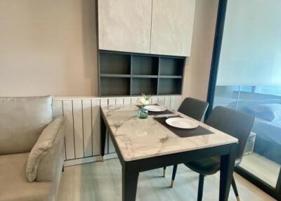 Modern dining area with a small table and two chairs