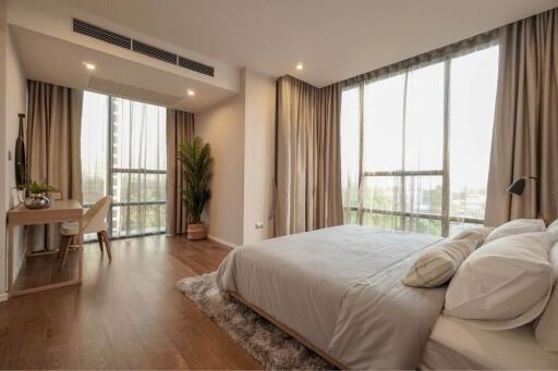 Modern bedroom with large windows and natural light