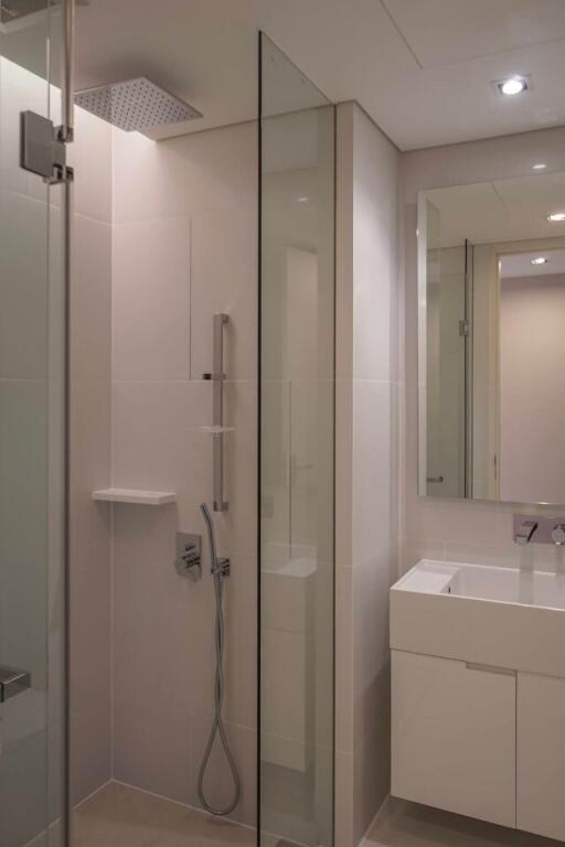 Modern bathroom with glass shower enclosure and vanity