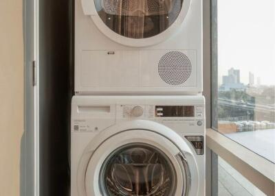 Laundry area with stacked washer and dryer
