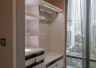 Modern closet with drawers and shelving in a high-rise apartment