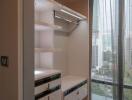 Modern closet with drawers and shelving in a high-rise apartment