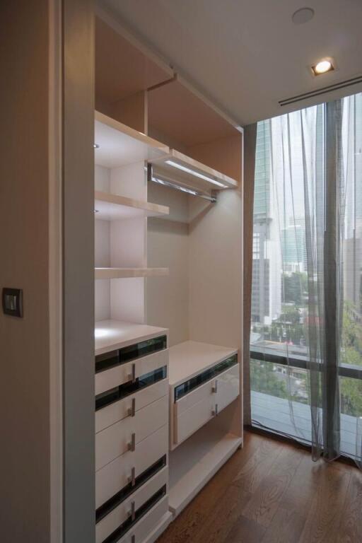 Modern closet with drawers and shelving in a high-rise apartment