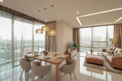 Modern living room with dining area and large windows