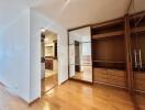 Bedroom with built-in wooden wardrobes and attached bathroom