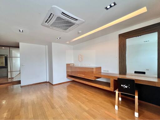 Modern living area with wooden flooring and built-in furniture