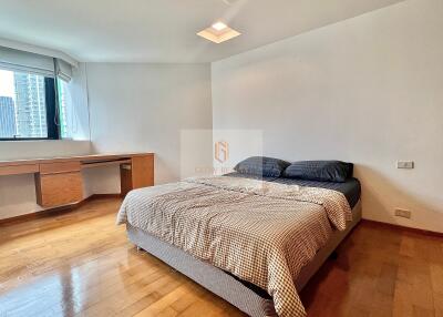 Cozy bedroom with wooden flooring and natural light