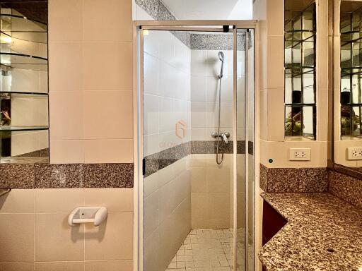 Modern bathroom with a shower enclosure and granite countertops