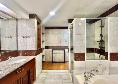 Modern bathroom with large shower, double sinks, and bathtub