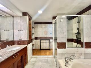 Modern bathroom with large shower, double sinks, and bathtub