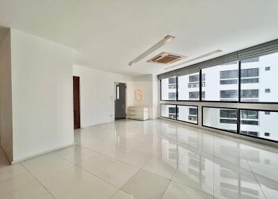 Spacious modern living room with large windows and ample natural light