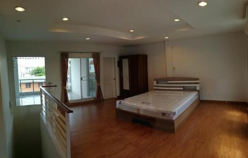 Spacious bedroom with a large bed and balcony access