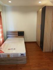 Bedroom with wooden floor and furniture