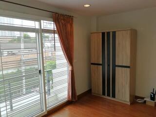 Bedroom with a large window and wardrobe