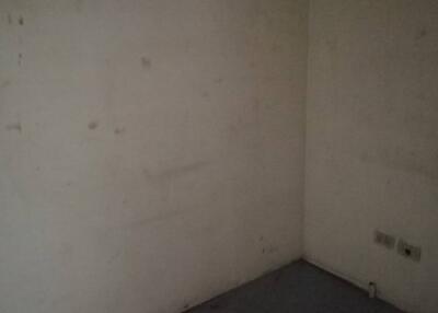 Dimly lit empty room with bare walls