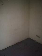 Dimly lit empty room with bare walls