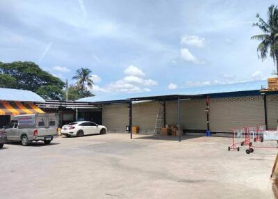 Parking area with multiple parked cars and warehouse buildings