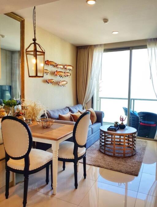 Brightly lit living room with dining area and balcony