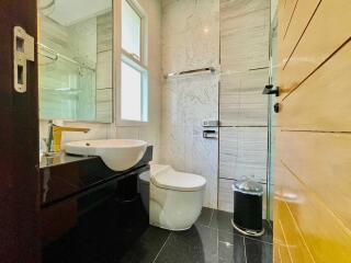 Modern bathroom with sink, toilet, and shower