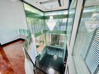 Elegant foyer with chandelier and large windows