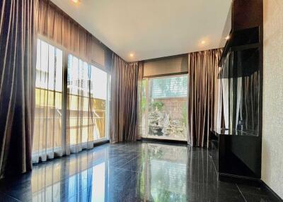 Modern living room with floor-to-ceiling windows and dark flooring