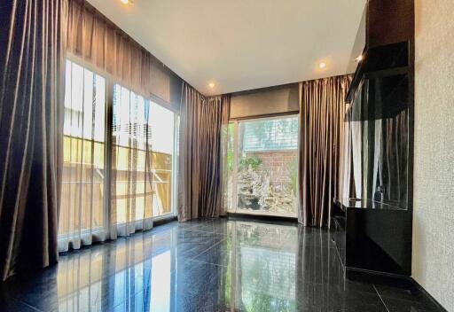 Modern living room with floor-to-ceiling windows and dark flooring