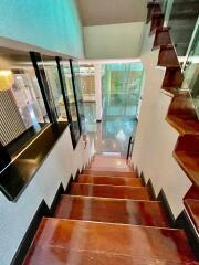 Modern staircase with wooden steps and glass railing