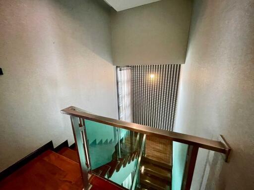 View of a staircase with modern railing and wooden steps