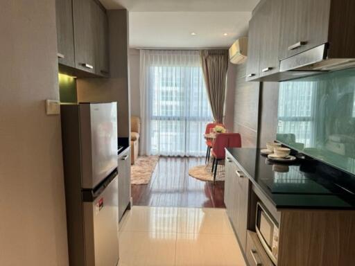 Modern kitchen leading to a cozy dining area