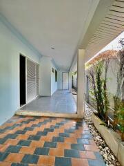 Covered outdoor patio with tiled flooring