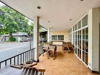 Spacious veranda area with wooden furniture