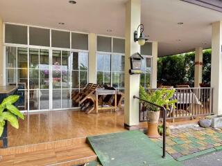 Covered patio with glass doors and outdoor furniture