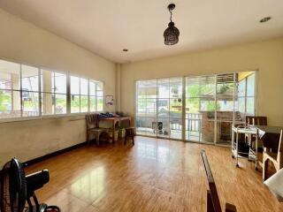 Spacious living area with large windows and hardwood floors