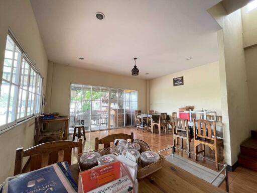 Spacious dining area with large windows and wooden furniture