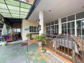 Front view of residential property with a patio and dining area