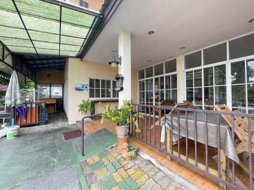 Front view of residential property with a patio and dining area