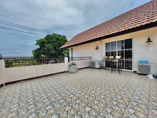 Spacious outdoor patio with roof tile and seating area