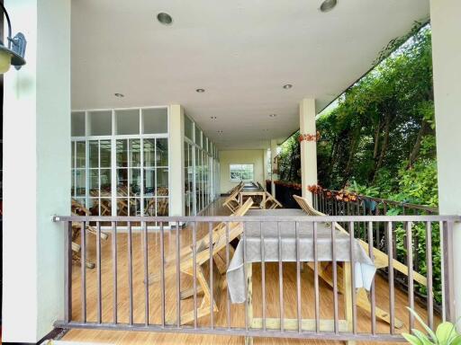 Outdoor lounge area with seating and greenery