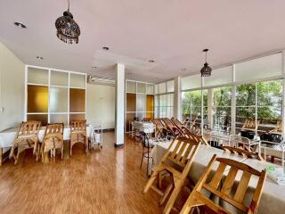 Spacious dining area with wooden furniture and large windows