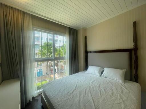 Bedroom with large window and bed