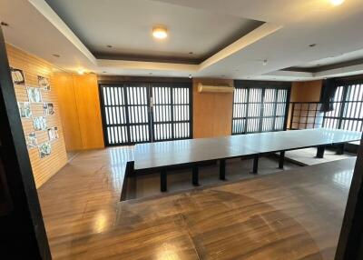 Modern conference room with large table and wooden flooring