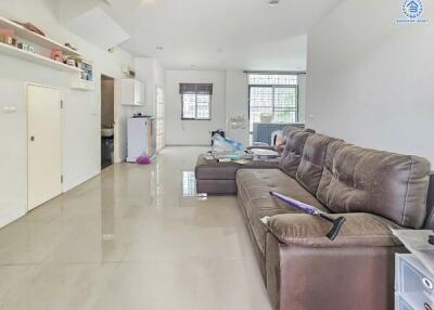 Spacious living room with a large sofa and open layout